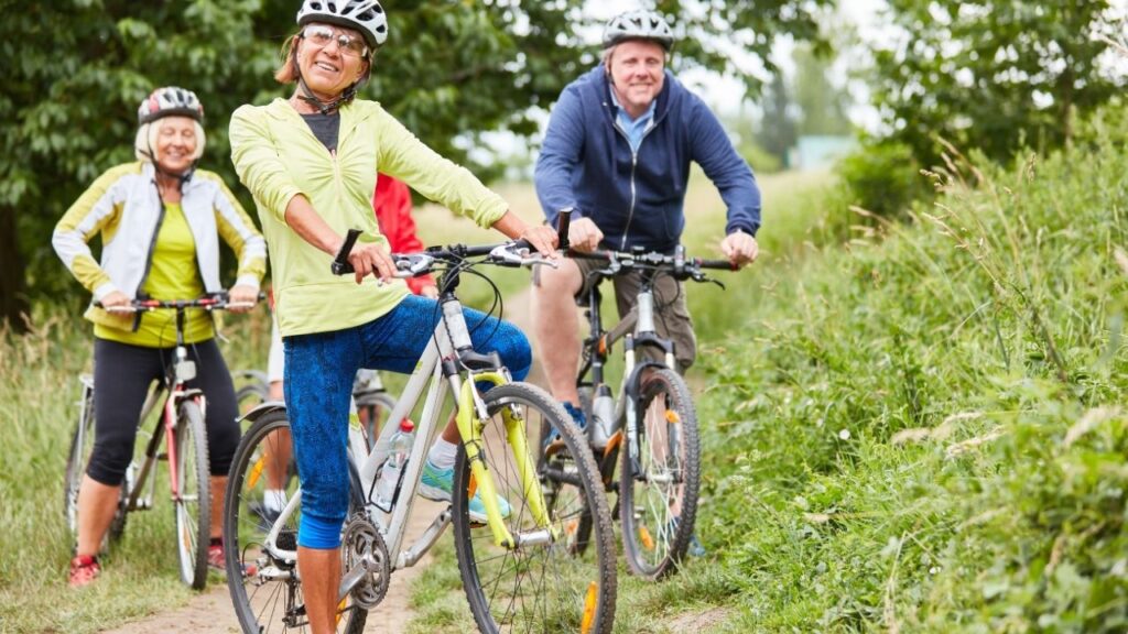 old cyclists riding bike